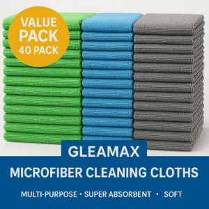 Stack of green, blue, and grey Gleamax microfiber towels (12x12 in / 30x30 cm) under spotlight, showing soft absorbent texture for cleaning surfaces.